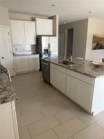 a bedroom with a bed and a television