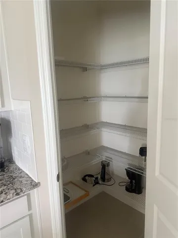 a large bed sitting in a bedroom and painting on the wall