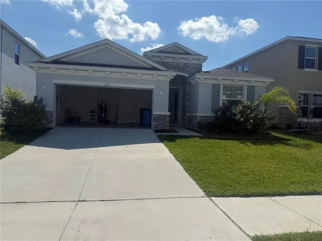 a view of an house with backyard space and balcony