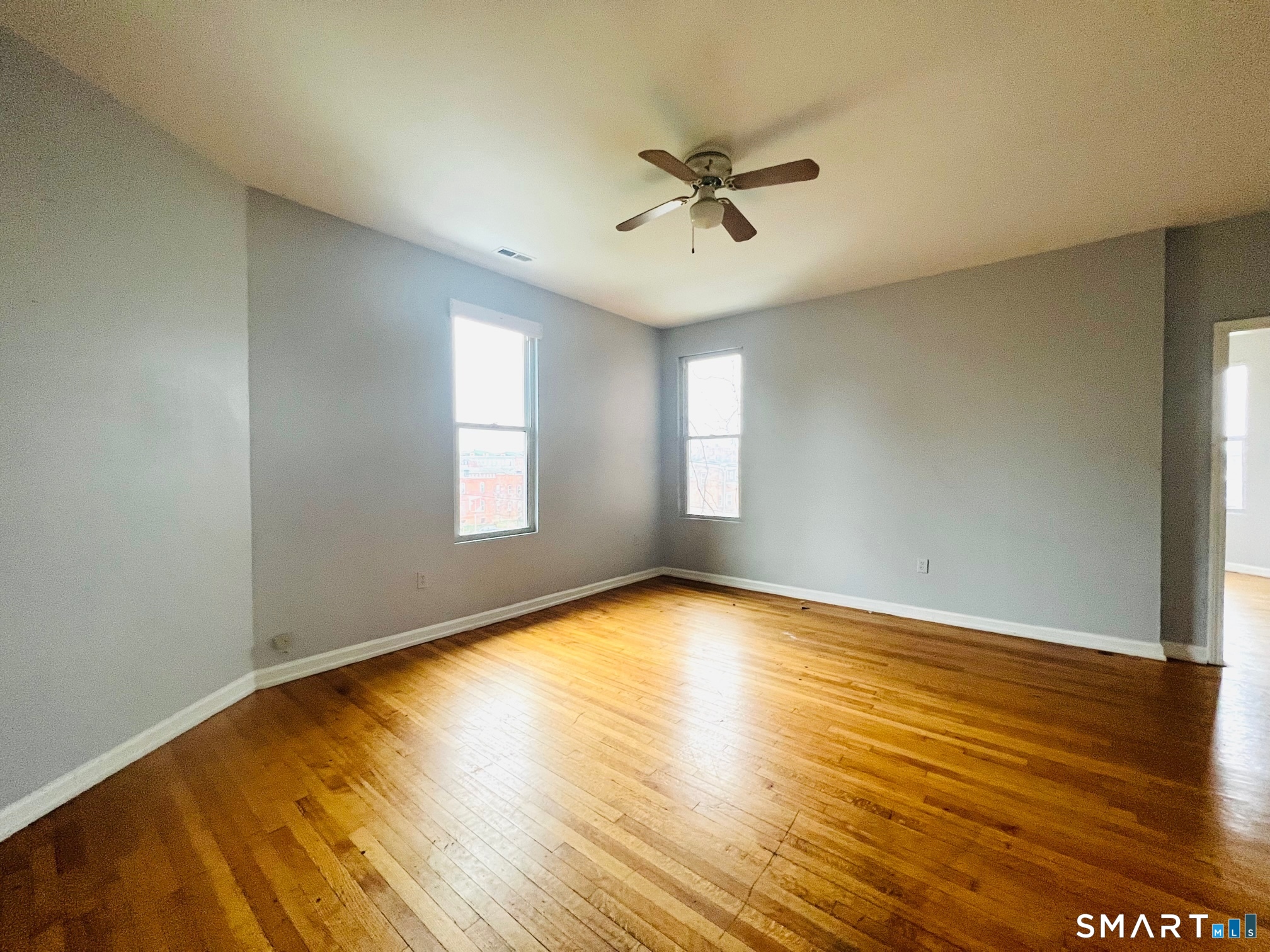162 William Street, Unit 3R Bridgeport, CT 06608 - Photo 2 of 7 a view of an empty room with wooden floor and a window