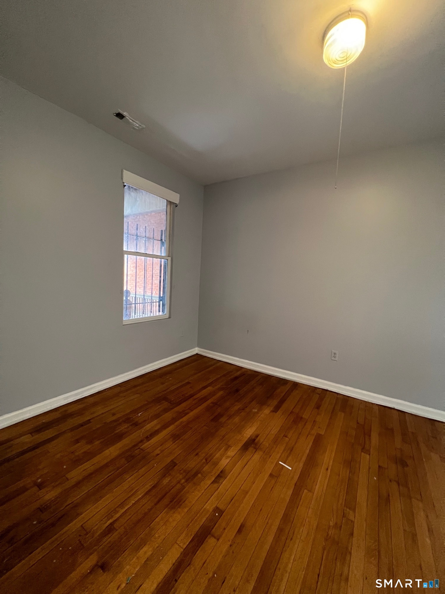 162 William Street, Unit 3R Bridgeport, CT 06608 - Photo 5 of 7 a view of empty room with wooden floor and fan