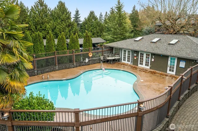 a view of a house with pool and trees