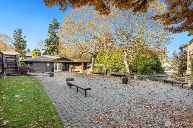 a view of a backyard with table and chairs under an umbrella