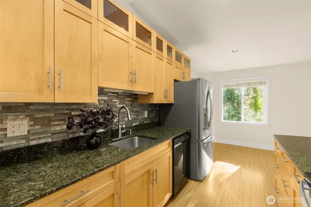a kitchen with sink and refrigerator
