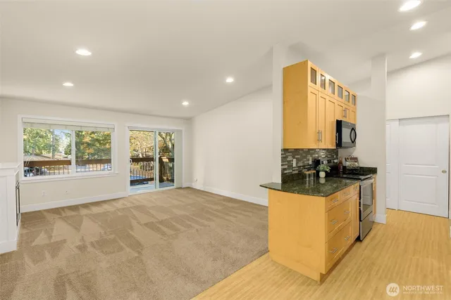 a kitchen with stainless steel appliances a stove a sink a counter top space and cabinets