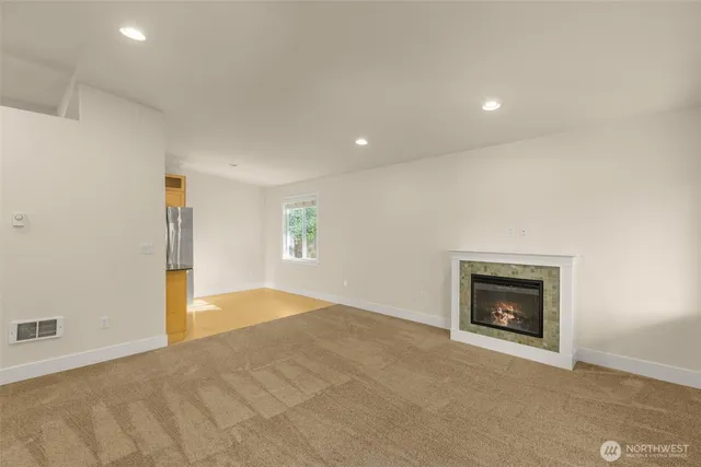 an empty room with a fireplace and a window