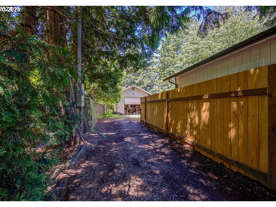 209 Southeast 214th Avenue Gresham, OR 97030 - Photo 1 of 5 a view of a backyard with large tree