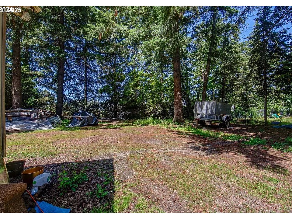 209 Southeast 214th Avenue Gresham, OR 97030 - Photo 3 of 5 a view of a yard with plants and trees