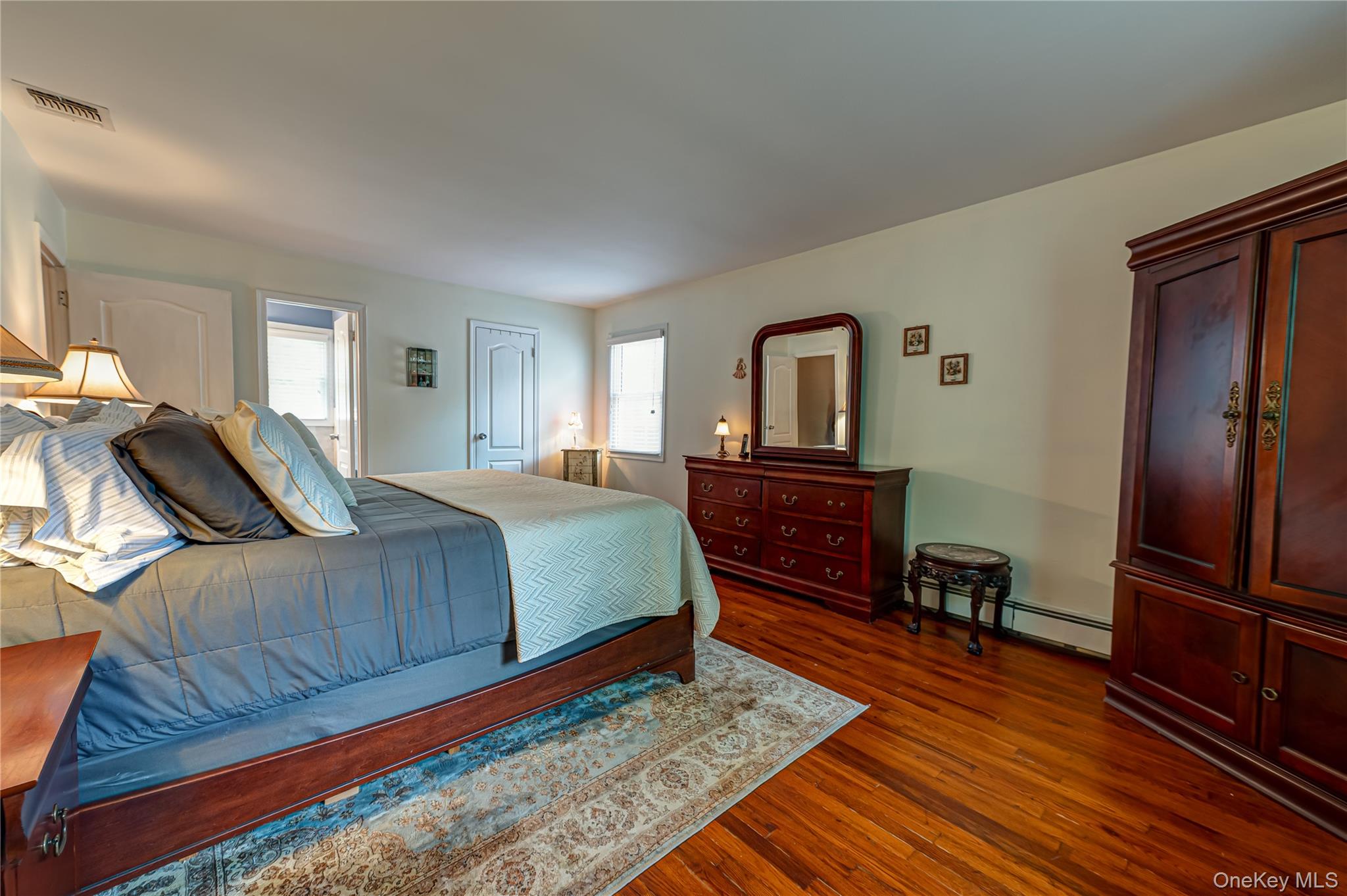 3 Thompson Hill Road St. James, NY 11780 - Photo 14 of 34 a bedroom with a bed and wooden floor