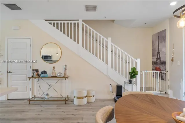 a view of a livingroom with wooden floor and furniture