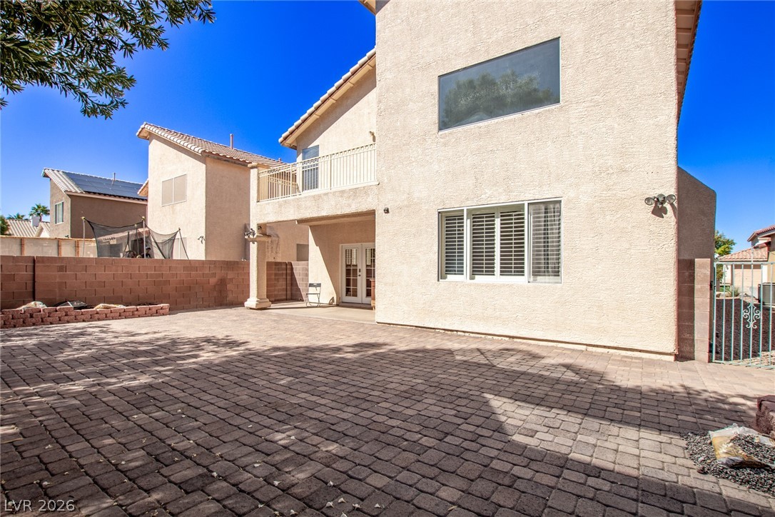 1477 Rancho Ridge Drive Henderson, NV 89012 - Photo 42 of 46 A spacious paver patio provides ample outdoor living space behind this well-maintained residence.