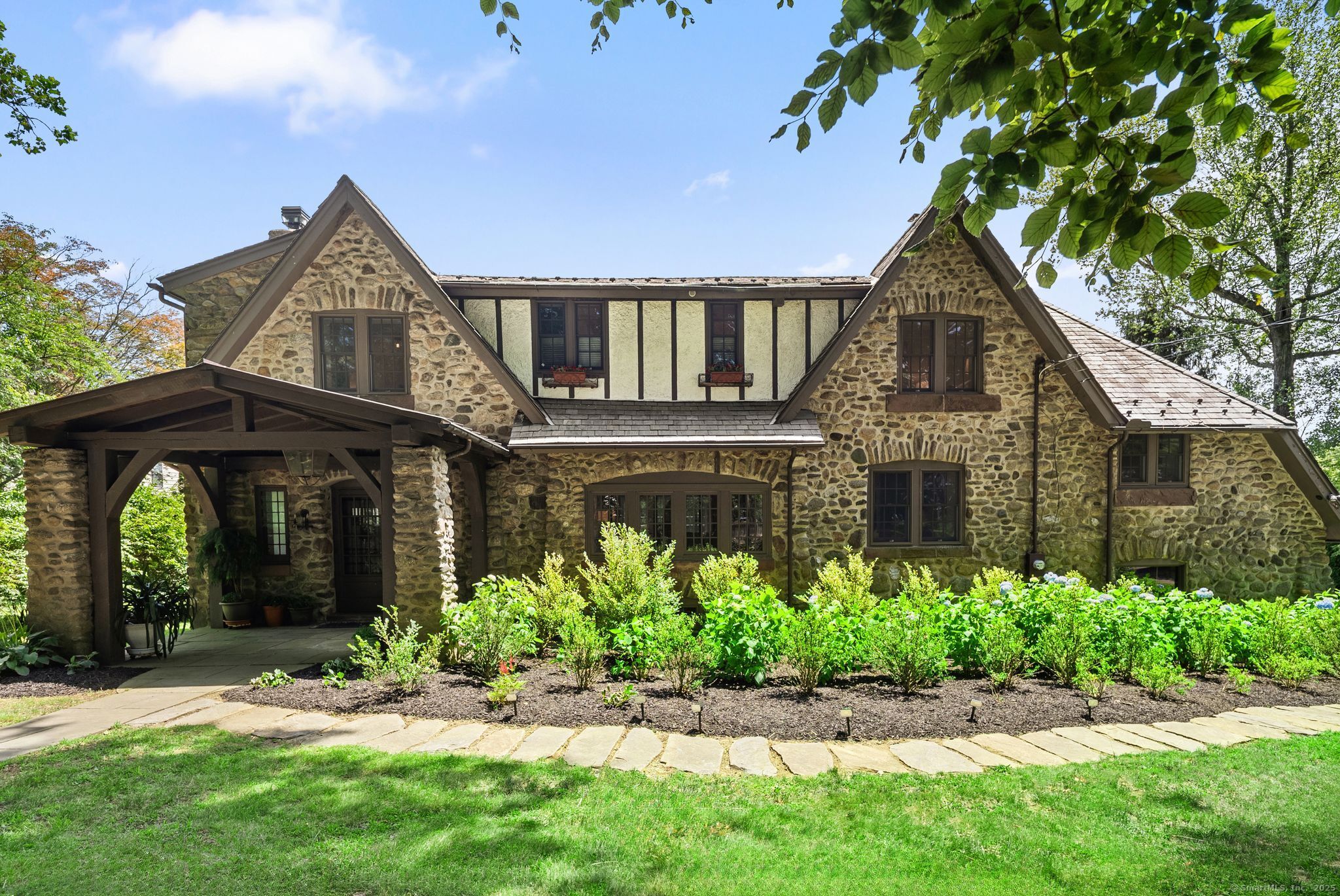 a front view of a house with a garden