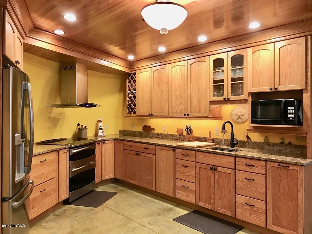 49 Forget Road Hawley, MA 01339 - Photo 6 of 30 a kitchen with stainless steel appliances granite countertop a sink and stove top oven