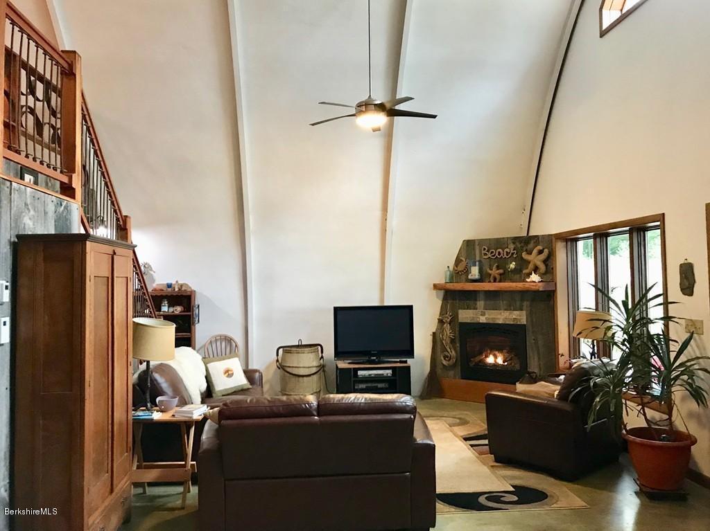 49 Forget Road Hawley, MA 01339 - Photo 9 of 30 a living room with furniture a flat screen tv and a fireplace