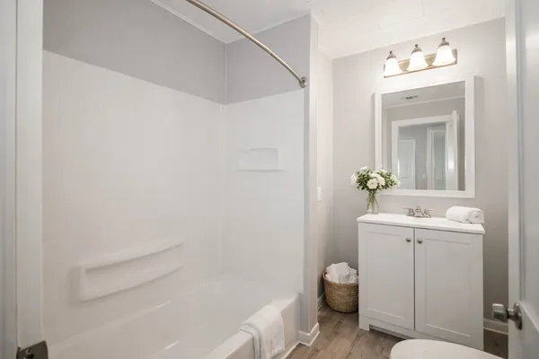 a bathroom with a sink toilet and shower