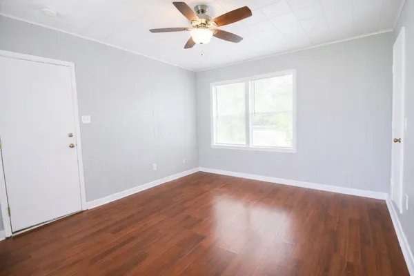 wooden floor in an empty room with a window