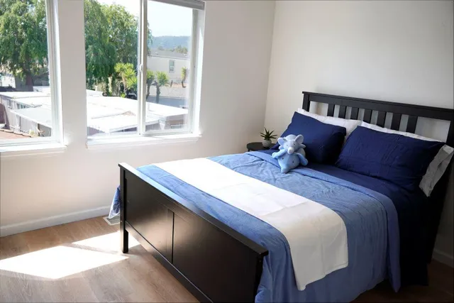 a bedroom with a bed and a window