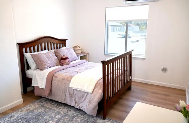 a bedroom with bed and a window