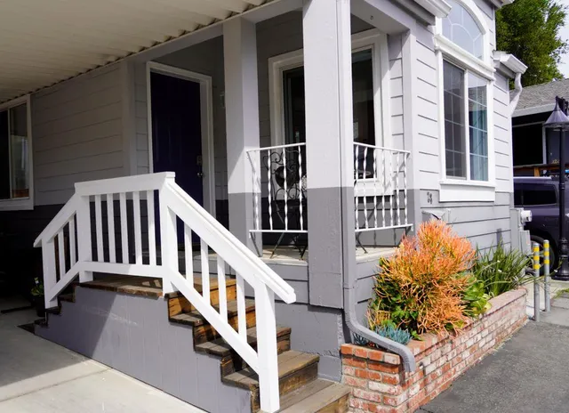a view of balcony with wooden wall and potted plants