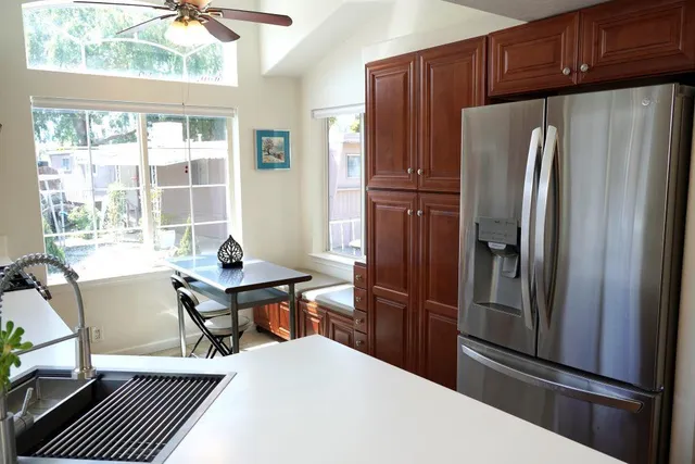 a kitchen with stainless steel appliances a refrigerator and wooden cabinets