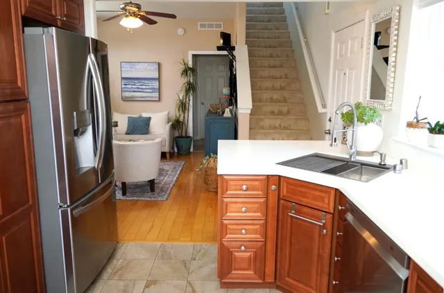 a kitchen with stainless steel appliances granite countertop a refrigerator and a sink