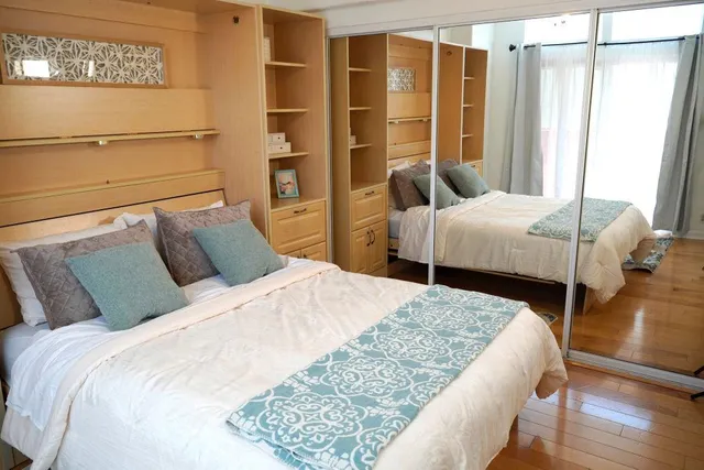 a bed sitting in a bedroom next to a window