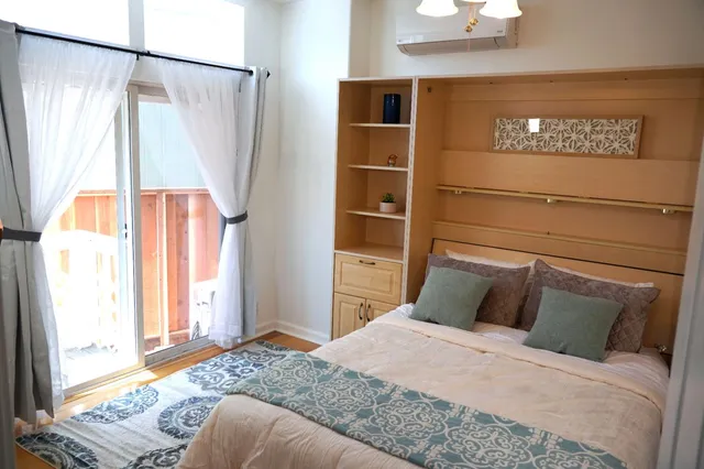 a bedroom with a bed and a window