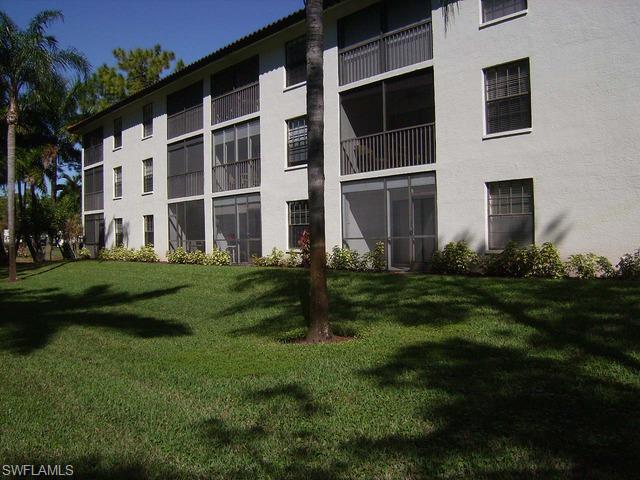 265 Deerwood Circle, Unit 3 Naples, FL 34113 - Photo 2 of 14 a backyard of a house with lots of green space