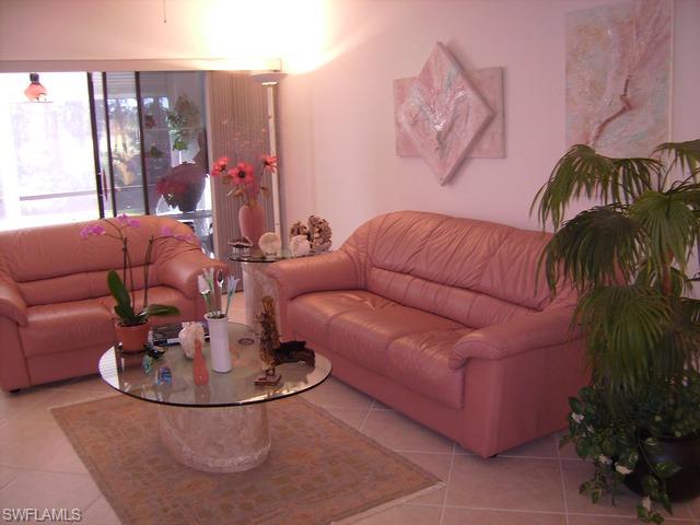 265 Deerwood Circle, Unit 3 Naples, FL 34113 - Photo 3 of 14 a living room with furniture and a potted plant