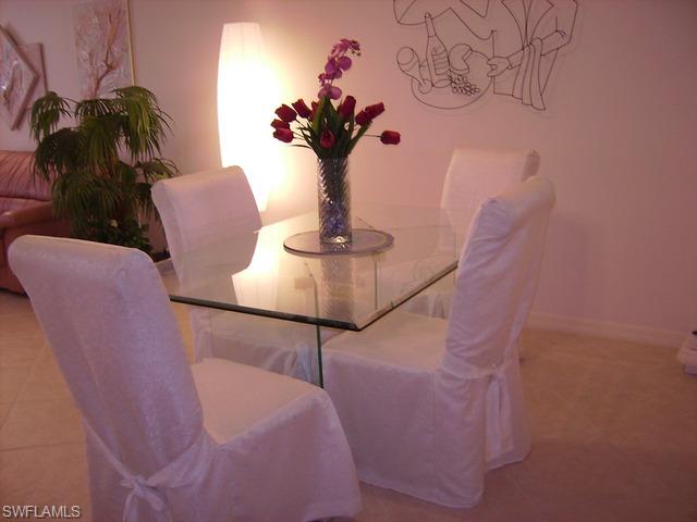 265 Deerwood Circle, Unit 3 Naples, FL 34113 - Photo 4 of 14 a vase of flowers sitting on a table