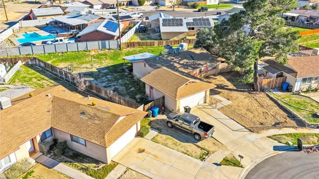 an aerial view of a house with a swimming pool