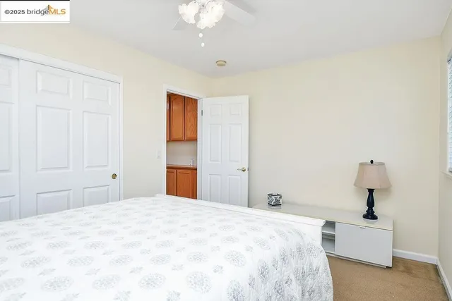 a bedroom with a bed and a potted plant