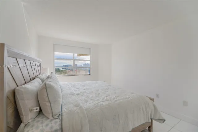 a bedroom with a bed and with a mirror