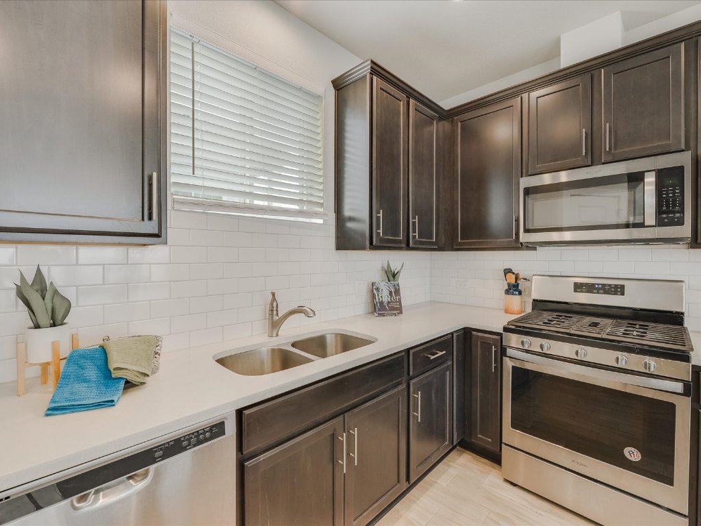 1916 Warely Lane Austin, TX 78741 - Photo 13 of 15 a kitchen with stainless steel appliances a stove sink and microwave
