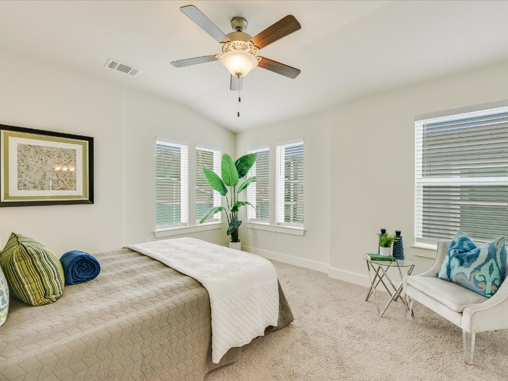 1916 Warely Lane Austin, TX 78741 - Photo 8 of 15 a bedroom with a bed couch and a large window