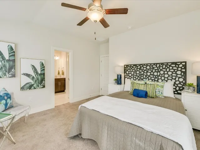 a bathroom with a bathtub sink vanity mirror and toilet