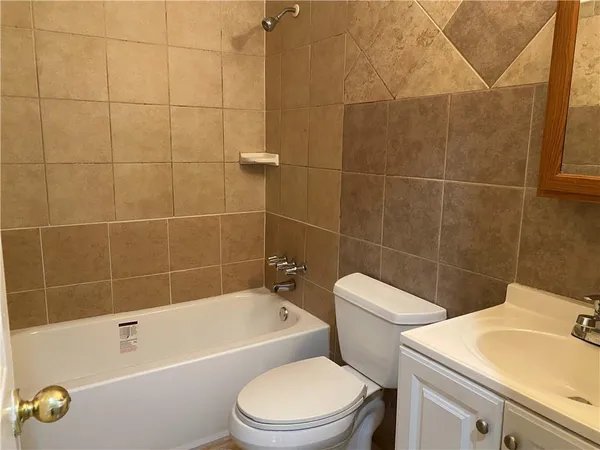 a bathroom with a sink a toilet and bathtub