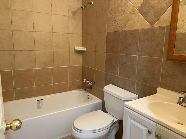 a bathroom with a sink a toilet and bathtub