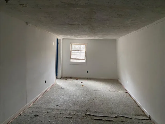 an empty room with a empty space and window