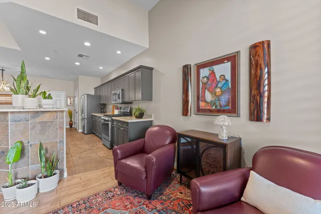 a living room with furniture and kitchen view