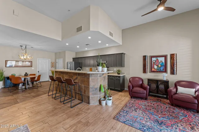 a living room with furniture a dining table and kitchen view