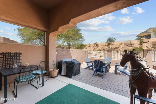 a view of a patio with table and chairs and potted plants