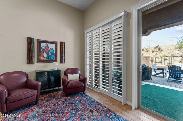a living room with furniture and a floor to ceiling window
