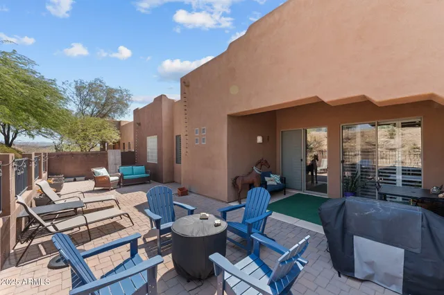 a view of a patio with couches table and chairs and potted plants