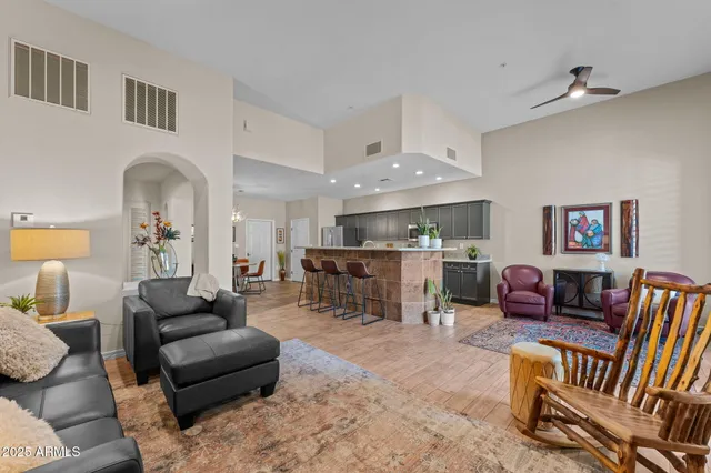 a living room with furniture and a kitchen