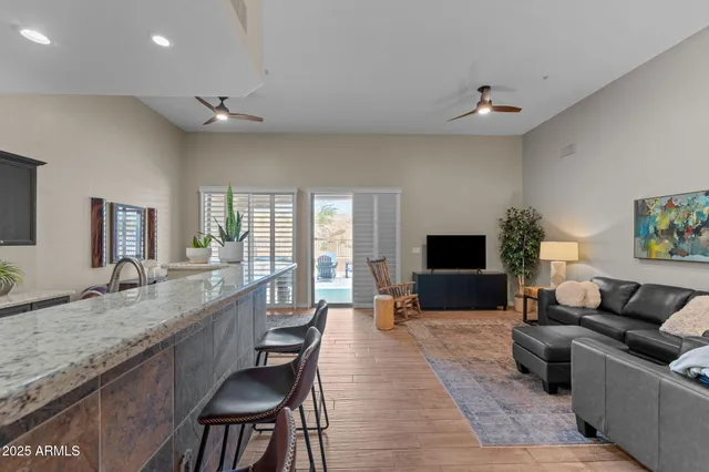 a living room with granite countertop furniture a couch and a flat screen tv