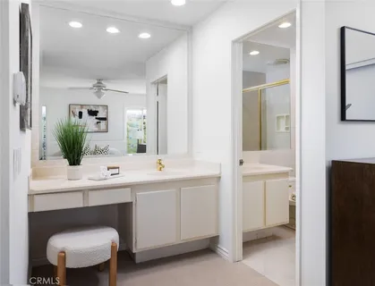 a bathroom with a toilet a sink a mirror and a shower