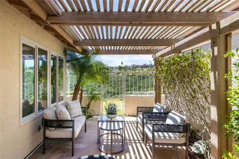 a balcony with furniture and a large window