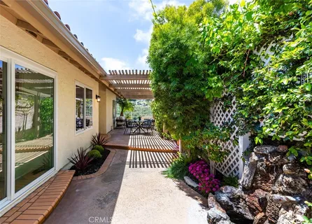 a balcony with outdoor seating and flowers