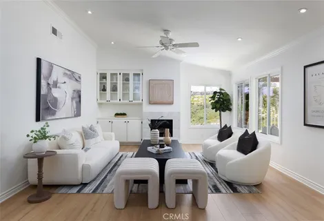 a living room with fireplace furniture and a wooden floor